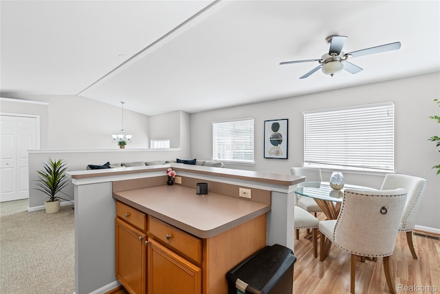 1015 Timber Ridge Ct, Grand Blanc, MI 48439 - kitchen featuring open floor plan, a center island, vaulted ceiling, ceiling fan, and brown cabinetry