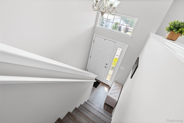 1015 Timber Ridge Ct, Grand Blanc, MI 48439 - foyer entrance with a chandelier, stairs, wood finished floors, and a towering ceiling