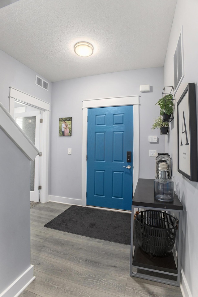 82 Dickens St, Spring Arbor, MI 49283 - foyer with wood finished floors, baseboards, and a textured ceiling