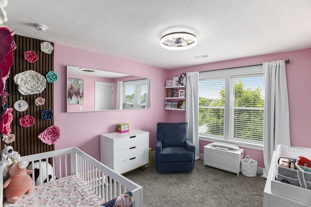 82 Dickens St, Spring Arbor, MI 49283 - bedroom with multiple windows, a crib, carpet floors, and a textured ceiling