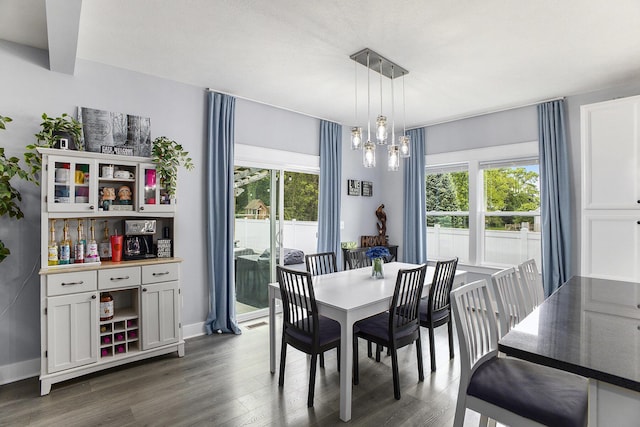 82 Dickens St, Spring Arbor, MI 49283 - dining space featuring dark wood-style flooring, healthy amount of natural light, a chandelier, and baseboards