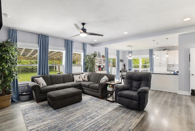 82 Dickens St, Spring Arbor, MI 49283 - living room with a ceiling fan, wood finished floors, a chandelier, recessed lighting, and a textured ceiling