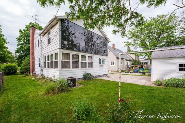 844 Dorroll St NE, Grand Rapids, MI 49505 - rear view of property with a yard, a patio area, and cooling unit