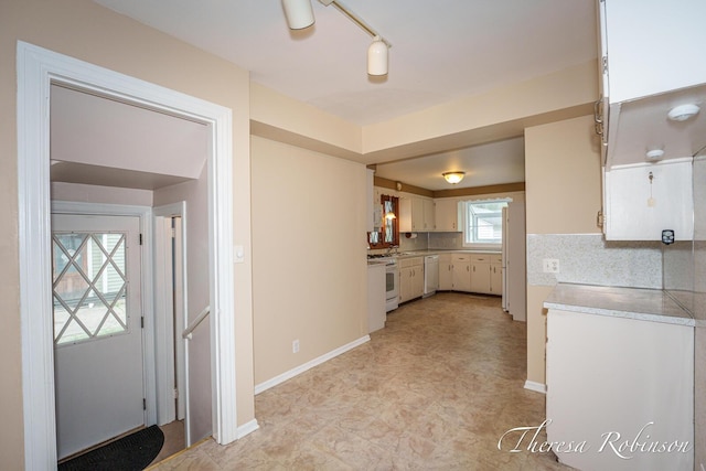 844 Dorroll St NE, Grand Rapids, MI 49505 - kitchen featuring white appliances, light countertops, baseboards, and decorative backsplash