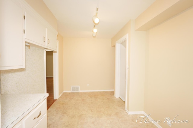 844 Dorroll St NE, Grand Rapids, MI 49505 - kitchen featuring light countertops and white cabinetry