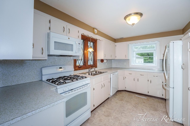 844 Dorroll St NE, Grand Rapids, MI 49505 - kitchen with white appliances, a sink, light countertops, tasteful backsplash, and white cabinetry