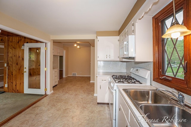 844 Dorroll St NE, Grand Rapids, MI 49505 - kitchen with white appliances, a sink, plenty of natural light, and white cabinets