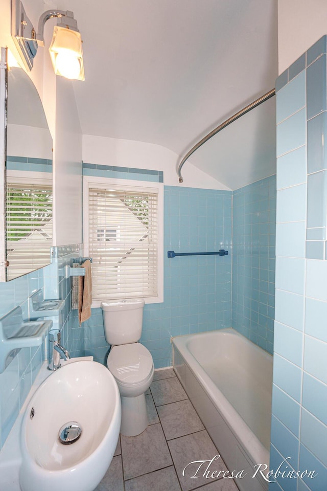 844 Dorroll St NE, Grand Rapids, MI 49505 - bathroom featuring tile walls, toilet, tile patterned floors, shower / bath combination, and vaulted ceiling