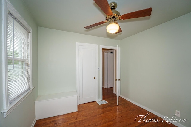 844 Dorroll St NE, Grand Rapids, MI 49505 - unfurnished bedroom with wood finished floors, baseboards, and a ceiling fan