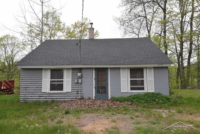 2114 Walter Rd, Beaverton, MI 48612 - view of front of home with roof with shingles and a chimney
