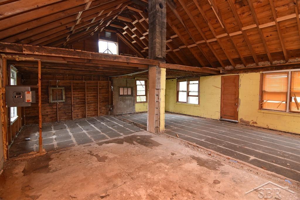 2114 Walter Rd, Beaverton, MI 48612 - miscellaneous room featuring electric panel and vaulted ceiling
