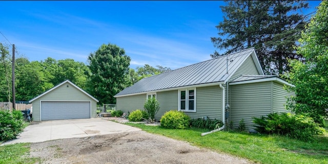 1027 E Railroad St, Hastings, MI 49058 - view of home's exterior featuring a garage, an outdoor structure, a standing seam roof, and metal roof
