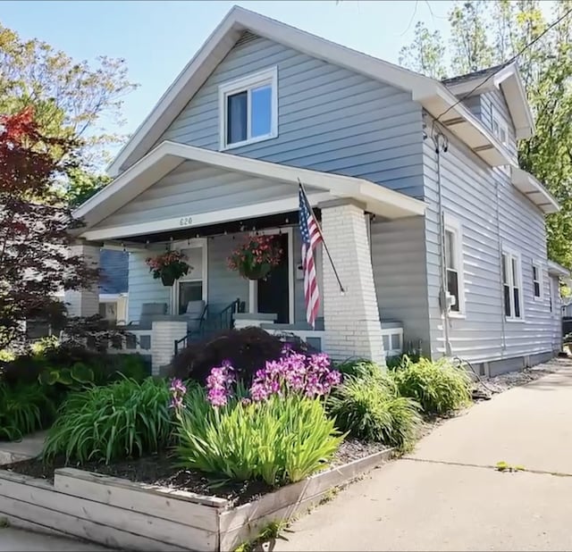 620 Emerald Ave NE, Grand Rapids, MI 49503 - view of side of home with a porch and brick siding