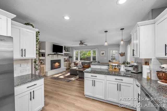 620 Emerald Ave NE, Grand Rapids, MI 49503 - kitchen featuring freestanding refrigerator, ceiling fan, a peninsula, white cabinetry, and recessed lighting
