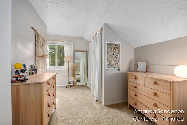620 Emerald Ave NE, Grand Rapids, MI 49503 - bedroom featuring a textured ceiling, lofted ceiling, light carpet, and baseboards