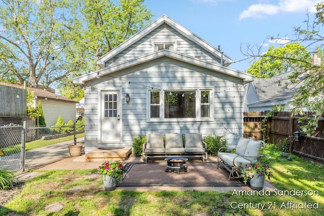 620 Emerald Ave NE, Grand Rapids, MI 49503 - rear view of property with an outdoor living space with a fire pit and a patio area