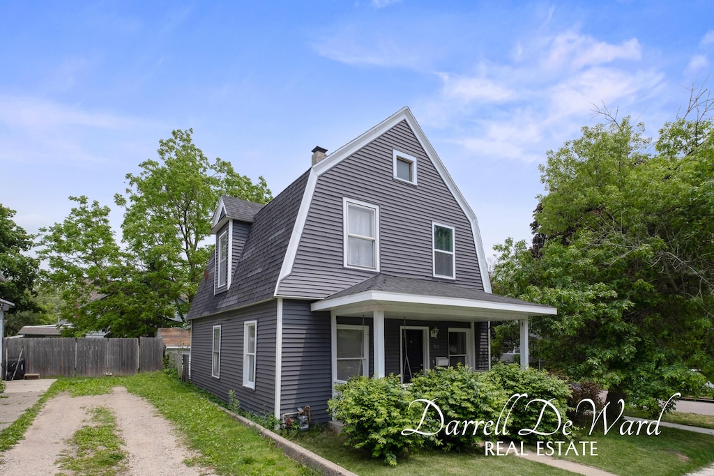 1107 Fountain St NE, Grand Rapids, MI 49503 - view of home's exterior featuring a gambrel roof, a chimney, and a shingled roof