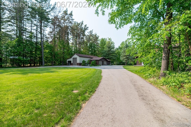3591 Curry Rd, Caro, MI 48723 - ranch-style house with a front lawn and driveway