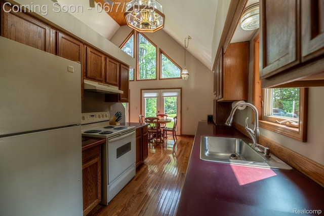 3591 Curry Rd, Caro, MI 48723 - kitchen featuring freestanding refrigerator, white electric range oven, under cabinet range hood, a chandelier, and brown cabinets