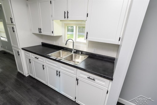 2832 N W River Rd, Sanford, MI 48657 - kitchen with a sink, dark countertops, white cabinetry, and dark wood-type flooring