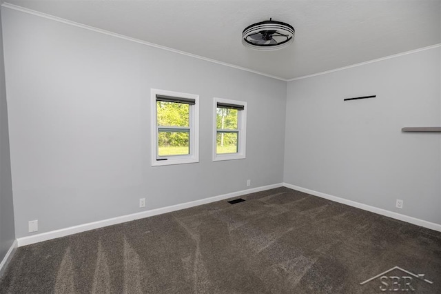 2832 N W River Rd, Sanford, MI 48657 - spare room featuring crown molding, baseboards, and dark carpet