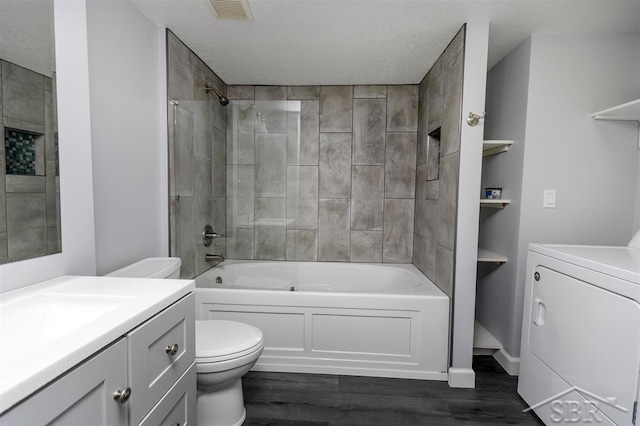 2832 N W River Rd, Sanford, MI 48657 - bathroom with washer / dryer, toilet, vanity, wood finished floors, and  shower combination
