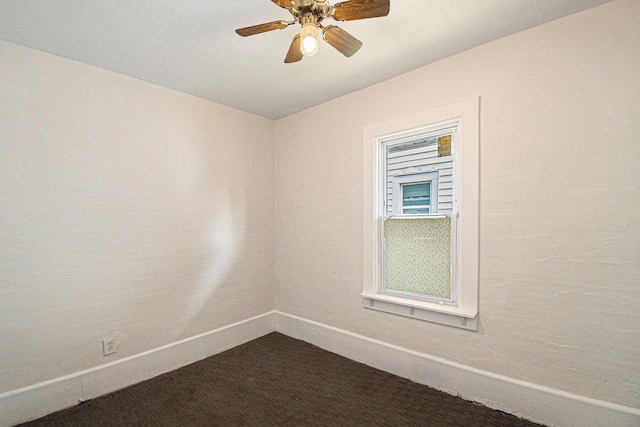 904 Riverview Ave, Lansing, MI 48915 - spare room with baseboards, dark carpet, and a ceiling fan