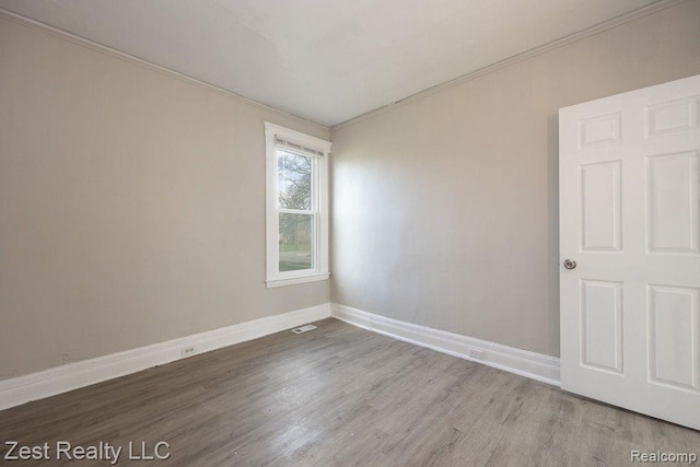 2977 Canton St, Detroit, MI 48207 - spare room with ornamental molding, wood finished floors, and baseboards