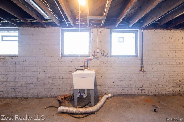 2977 Canton St, Detroit, MI 48207 - basement with plenty of natural light, brick wall, and a sink