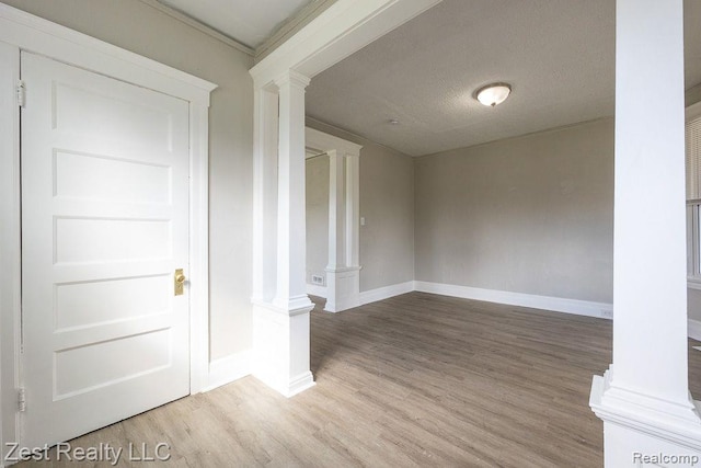 2977 Canton St, Detroit, MI 48207 - unfurnished room with decorative columns, baseboards, and wood finished floors