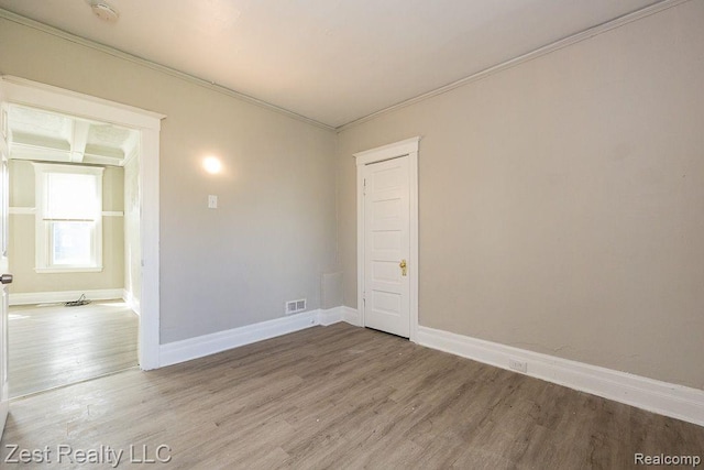 2977 Canton St, Detroit, MI 48207 - empty room featuring wood finished floors, a smoke detector, crown molding, and baseboards