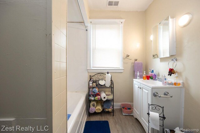 2977 Canton St, Detroit, MI 48207 - bathroom with vanity, wood finished floors, and baseboards