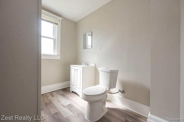 2977 Canton St, Detroit, MI 48207 - half bath featuring vanity, toilet, wood finished floors, and baseboards
