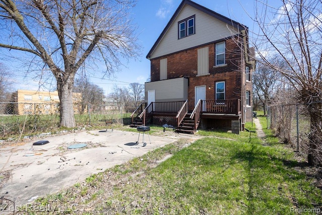 2977 Canton St, Detroit, MI 48207 - rear view of house featuring brick siding, a wooden deck, a patio, and stairway