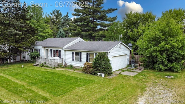 3500 Hogarth Ave, Flint, MI 48532 - ranch-style house featuring a garage, a front lawn, a wooden deck, and driveway