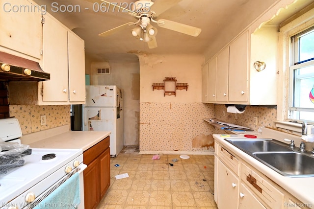 3500 Hogarth Ave, Flint, MI 48532 - kitchen with white appliances, under cabinet range hood, a sink, light floors, and a ceiling fan