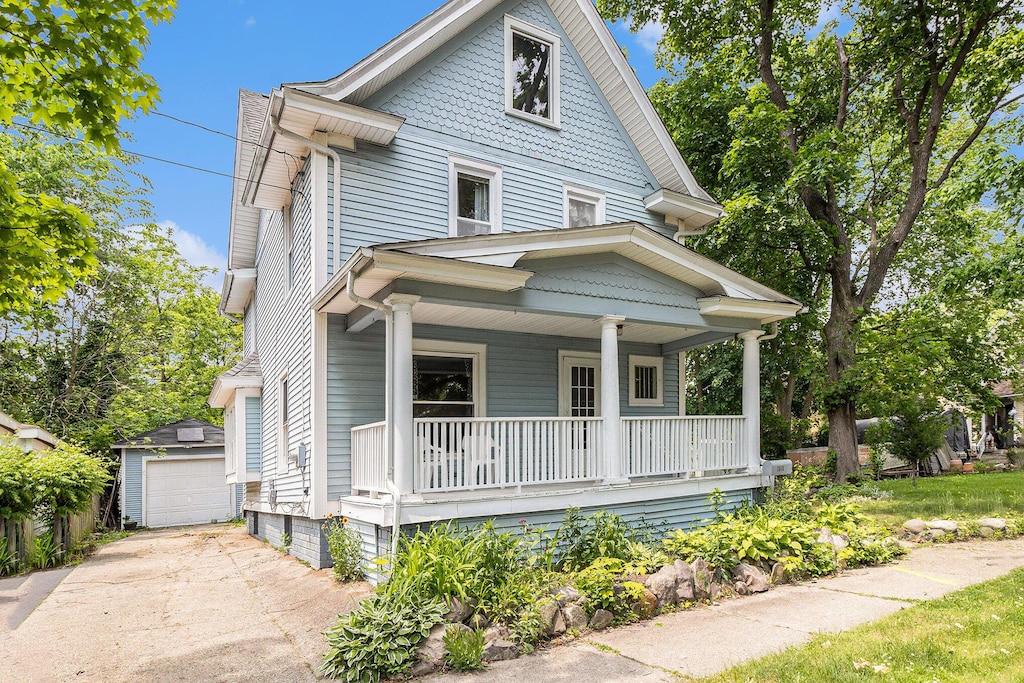 1518 Fair St, Kalamazoo, MI 49001 - victorian house featuring covered porch, an outbuilding, and a detached garage