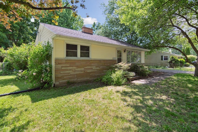1279 Cunningham, Jackson, MI 49201 - view of front of property with stone siding and a chimney
