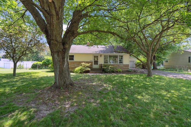 1279 Cunningham, Jackson, MI 49201 - ranch-style house featuring an attached garage, driveway, a chimney, and brick siding