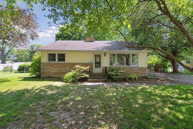 1279 Cunningham, Jackson, MI 49201 - view of front facade with stone siding, entry steps, and a chimney