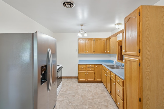 1279 Cunningham, Jackson, MI 49201 - kitchen with stainless steel fridge with ice dispenser, a sink, light countertops, baseboards, and decorative light fixtures