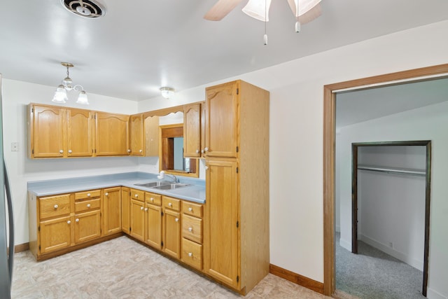1279 Cunningham, Jackson, MI 49201 - kitchen with a sink, ceiling fan, light countertops, hanging light fixtures, and baseboards