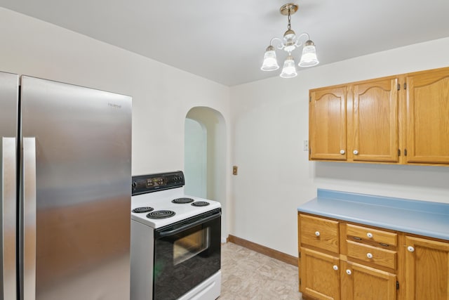 1279 Cunningham, Jackson, MI 49201 - kitchen featuring electric range, freestanding refrigerator, arched walkways, light countertops, and pendant lighting