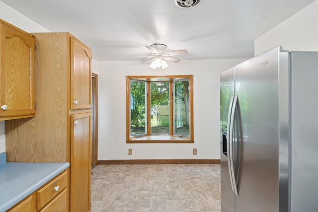 1279 Cunningham, Jackson, MI 49201 - kitchen with stainless steel fridge, a ceiling fan, light countertops, and baseboards