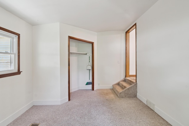 1279 Cunningham, Jackson, MI 49201 - unfurnished bedroom featuring light colored carpet, baseboards, and a closet