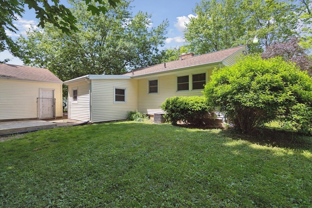 1279 Cunningham, Jackson, MI 49201 - back of property featuring a yard, central AC, and a chimney