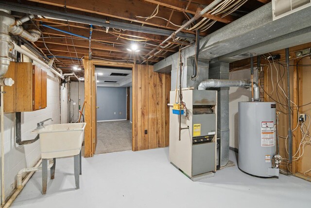 1279 Cunningham, Jackson, MI 49201 - unfinished basement with gas water heater and a sink