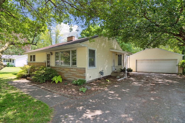 1279 Cunningham, Jackson, MI 49201 - ranch-style house with a chimney, an outbuilding, a garage, and stone siding