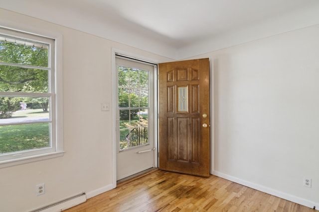 1279 Cunningham, Jackson, MI 49201 - foyer featuring plenty of natural light, a baseboard radiator, light wood finished floors, and baseboards