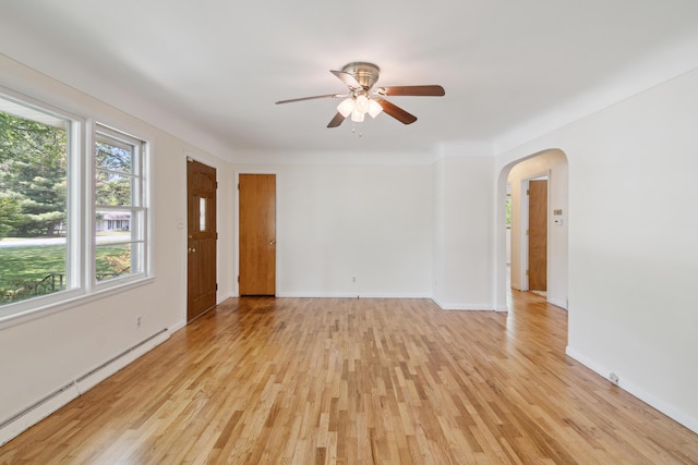 1279 Cunningham, Jackson, MI 49201 - unfurnished room featuring baseboard heating, ceiling fan, plenty of natural light, and arched walkways